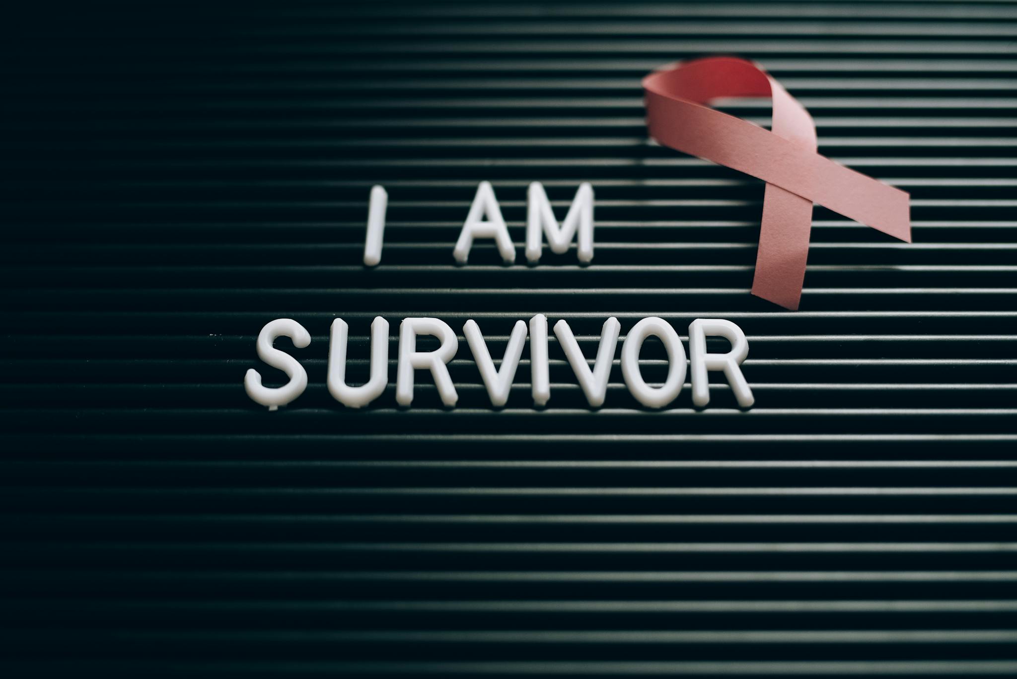 Inspiring message with a pink ribbon symbolizing breast cancer survival and awareness.